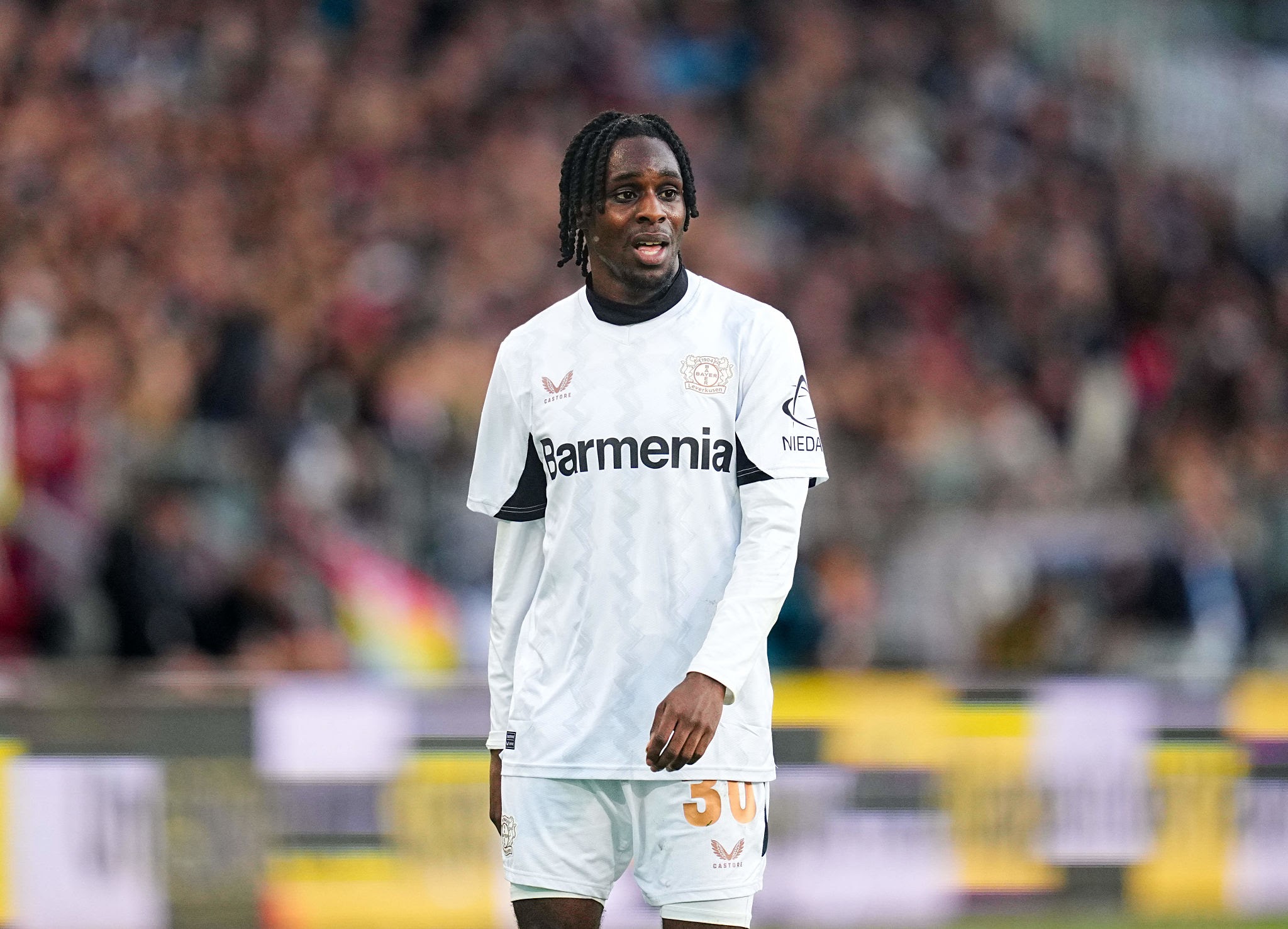 Jeremie Frimpong of Bayer 04 Leverkusen  looks on during the 1. Bundesliga match between St. Pauli and Bayer 04 Leverkusen at Millerntor, Hamburg, Germany on April 20, 2025.  (Photo by Ulrik Pedersen/NurPhoto via Getty Images)